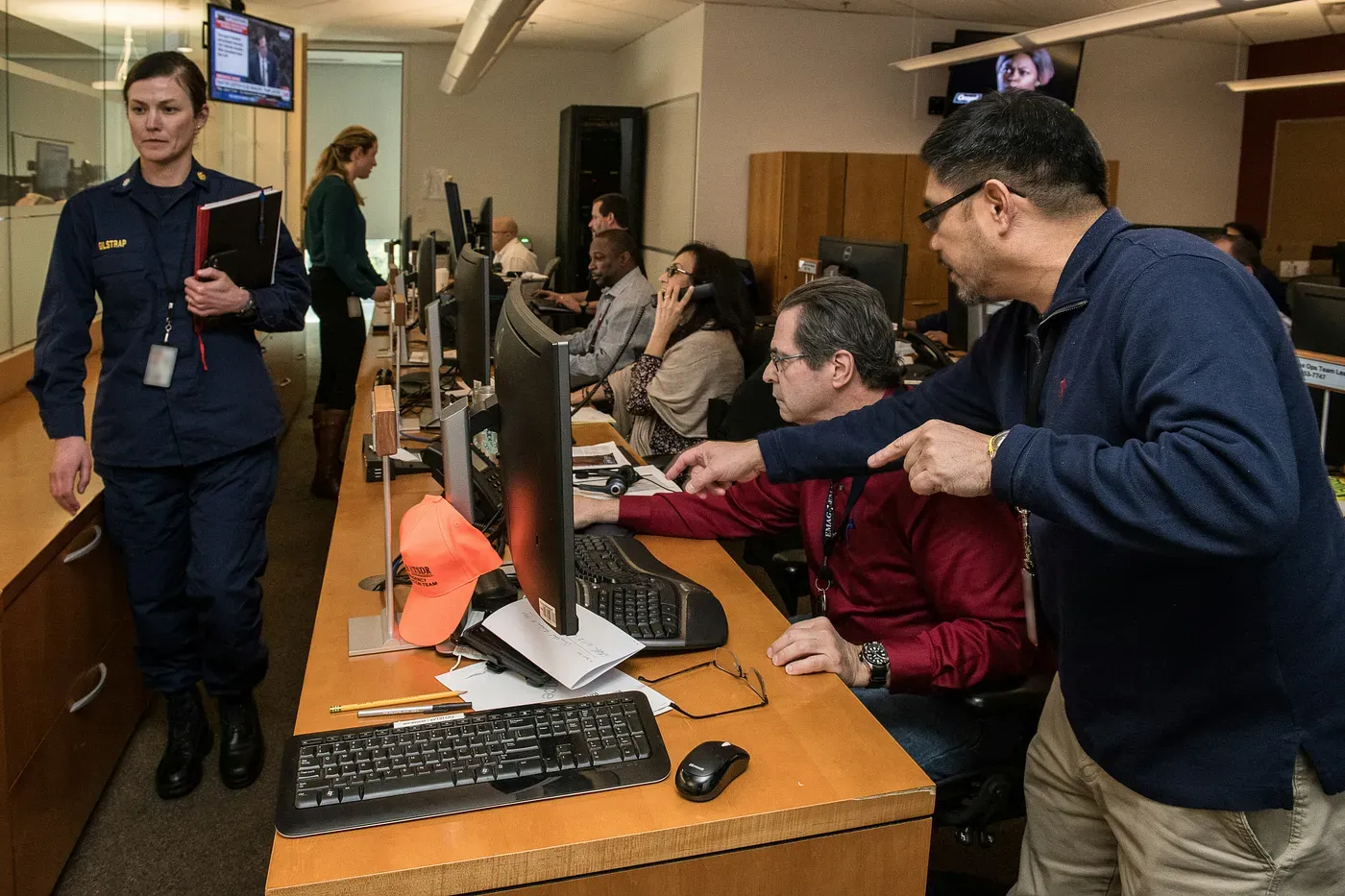 Emergency staff actively responding to a crisis—coordinating, communicating, and managing urgent tasks under pressure.